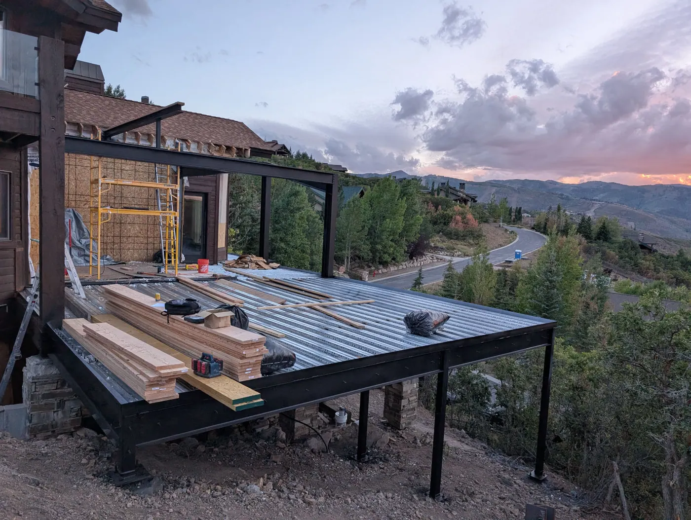 Elevated deck and addition — Steel structure carried over grade on a sloped lot