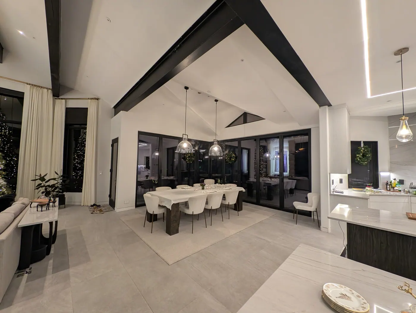 Finished great room, exposed steel at the vault — The completed side of a structural remodel — steel carrying the vault so the space could open up, left exposed as a finish element