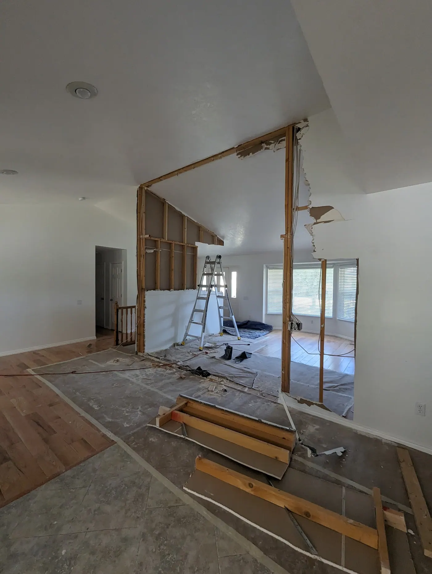 Load-bearing wall removal in progress — Framing exposed where an interior bearing wall is being taken out